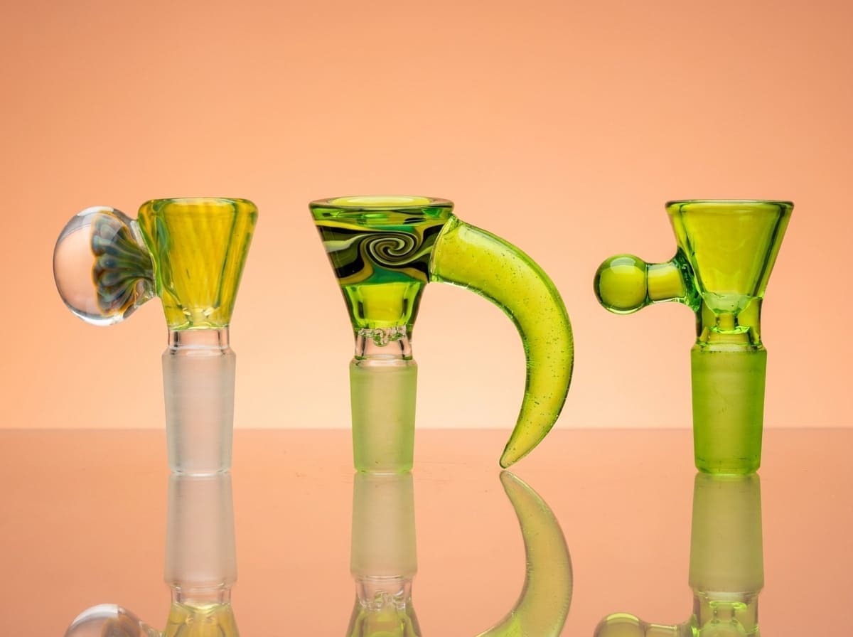 Three green glass bowls on a peach background